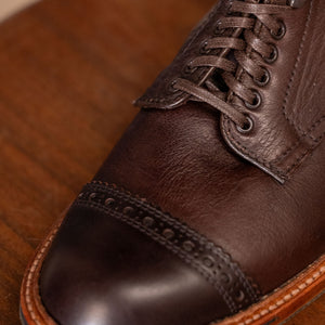 Brown leather cap toe boots close up on toe