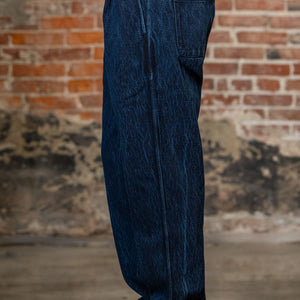 A person shown from the waist down wearing the 3sixteen Easy Pant - Indigo Kendo Cloth with side pockets 