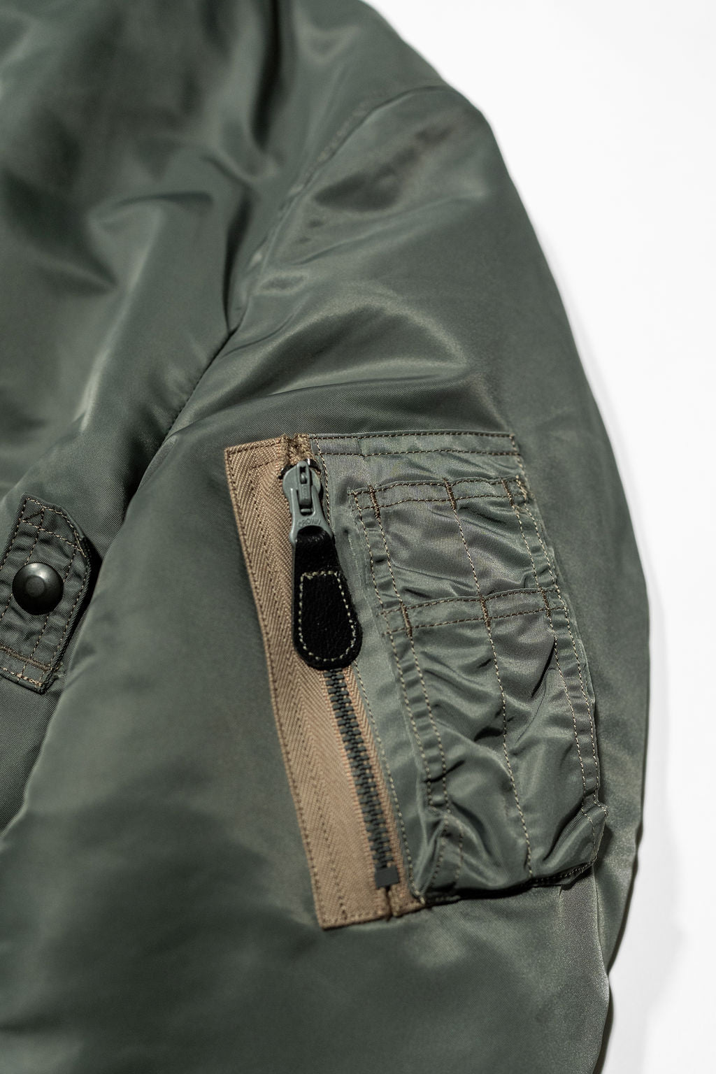 Buzz Rickson's BR14920 Type MA-1 Jacket in Green - Laying flat, close up on sleeve pocket
