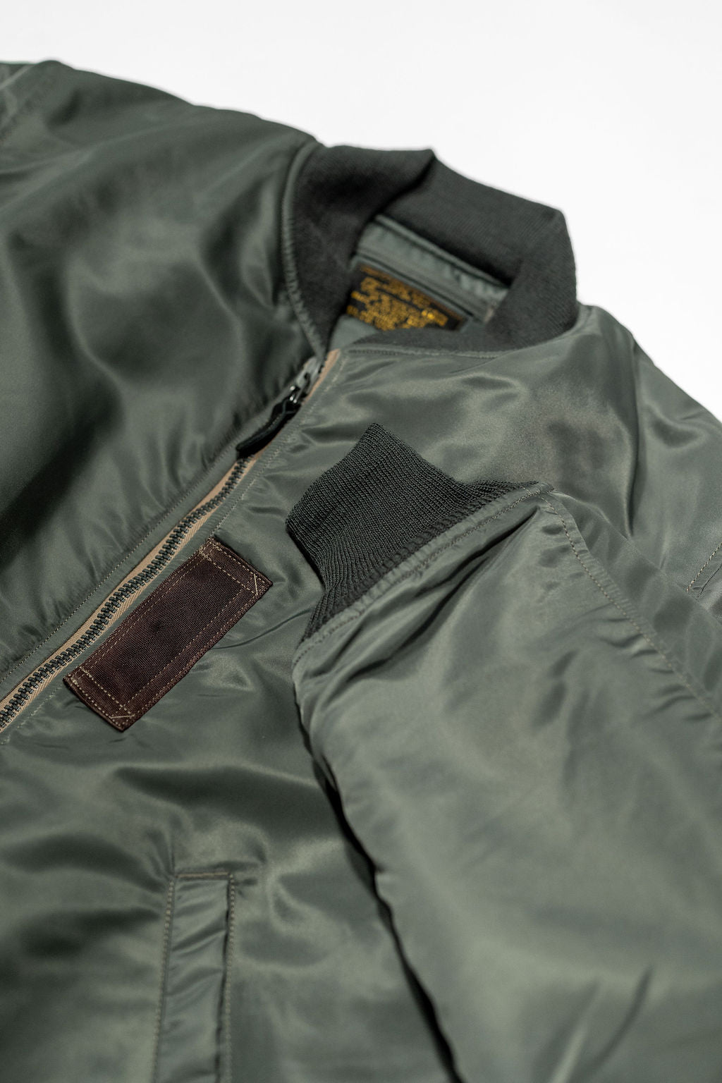 Buzz Rickson's BR14920 Type MA-1 Jacket in Green - Laying flat, front view showing cuff