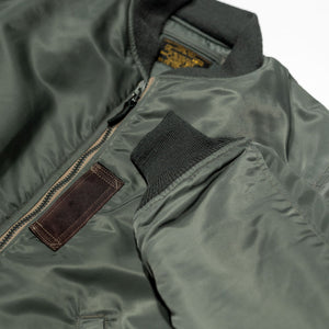 Buzz Rickson's BR14920 Type MA-1 Jacket in Green - Laying flat, front view showing cuff