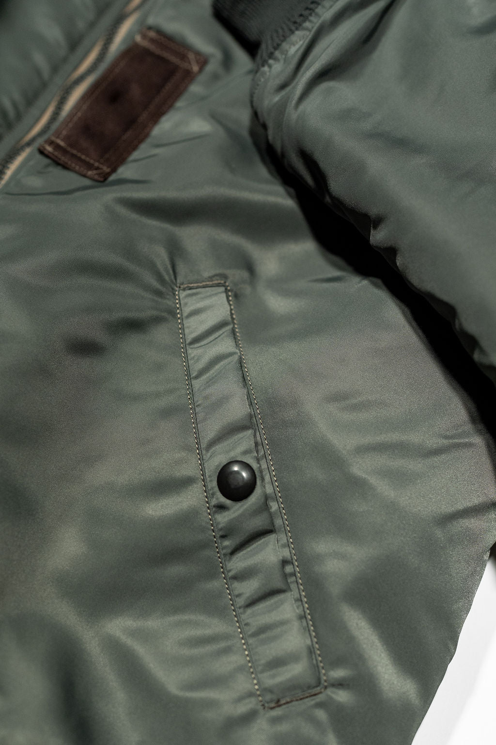 Buzz Rickson's BR14920 Type MA-1 Jacket in Green - Laying flat, close-up on pocket