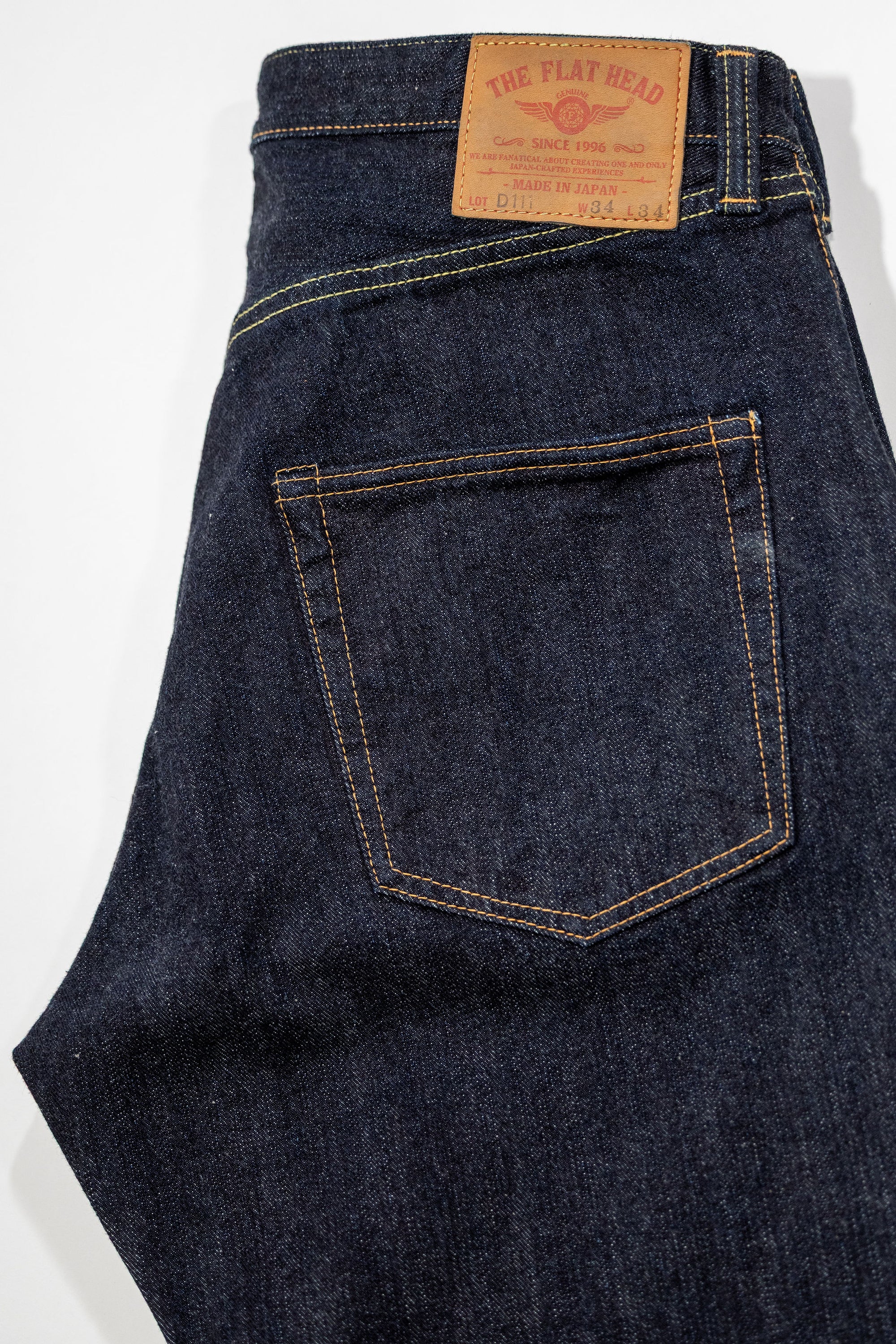 Indigo denim jeans wide cut back view laying flat