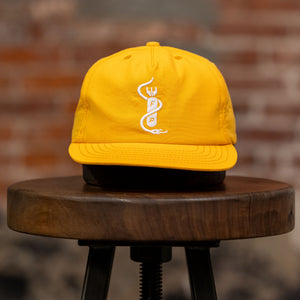 Franklin & Poe Surf Cap - Nylon Gold on stool, facing the front