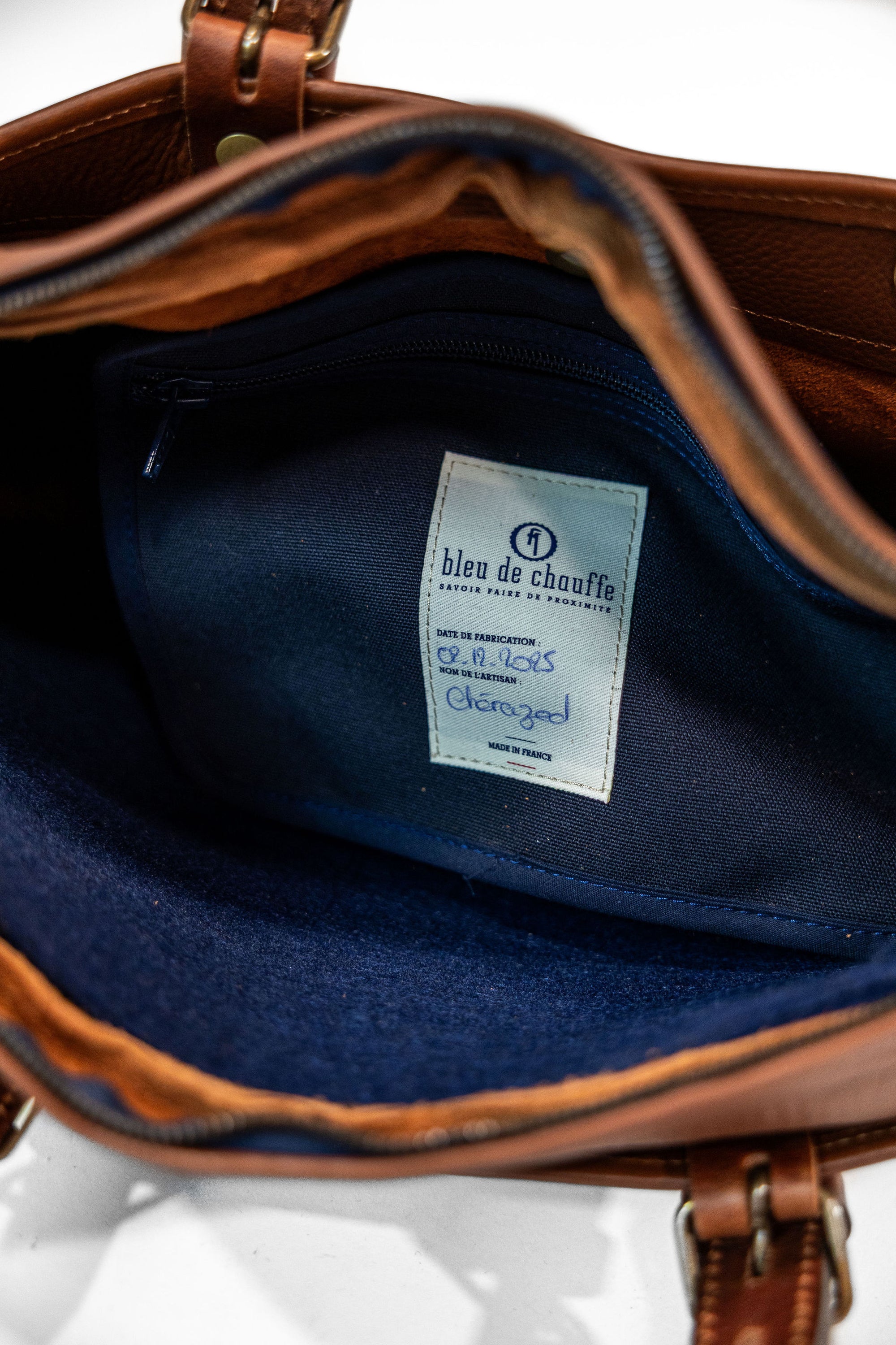 Bleu de Chauffe Folder Business Bag - Amber Brown. detail shot of inside tag