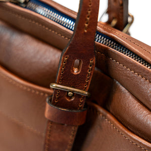 Bleu de Chauffe Folder Business Bag - Amber Brown. detail shot of attached bag strap
