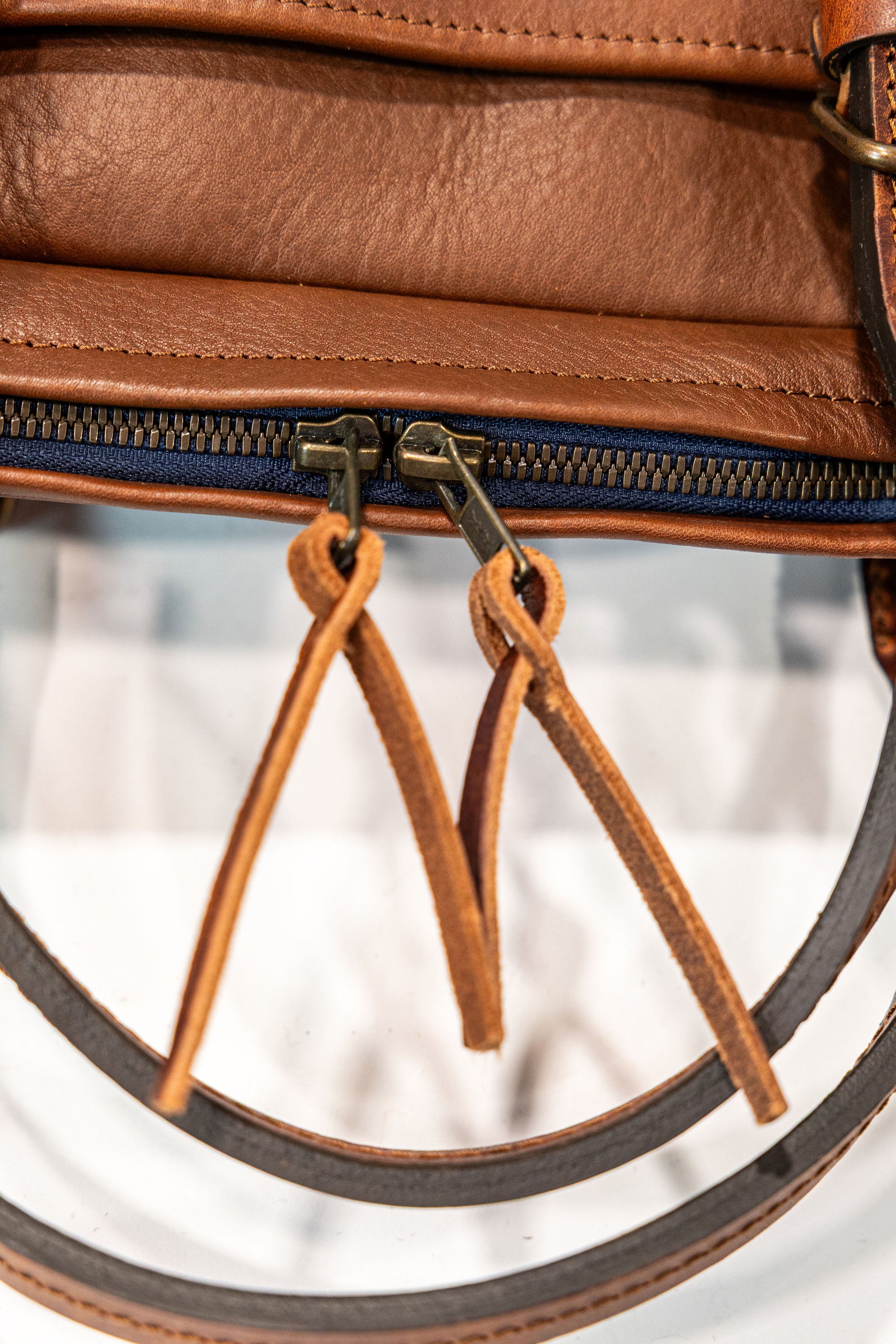 Bleu de Chauffe Folder Business Bag - Amber Brown. detail shot of zipper leather straps
