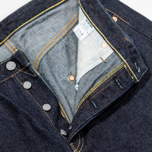 Indigo denim jeans wide cut front view laying flat close up on open fly
