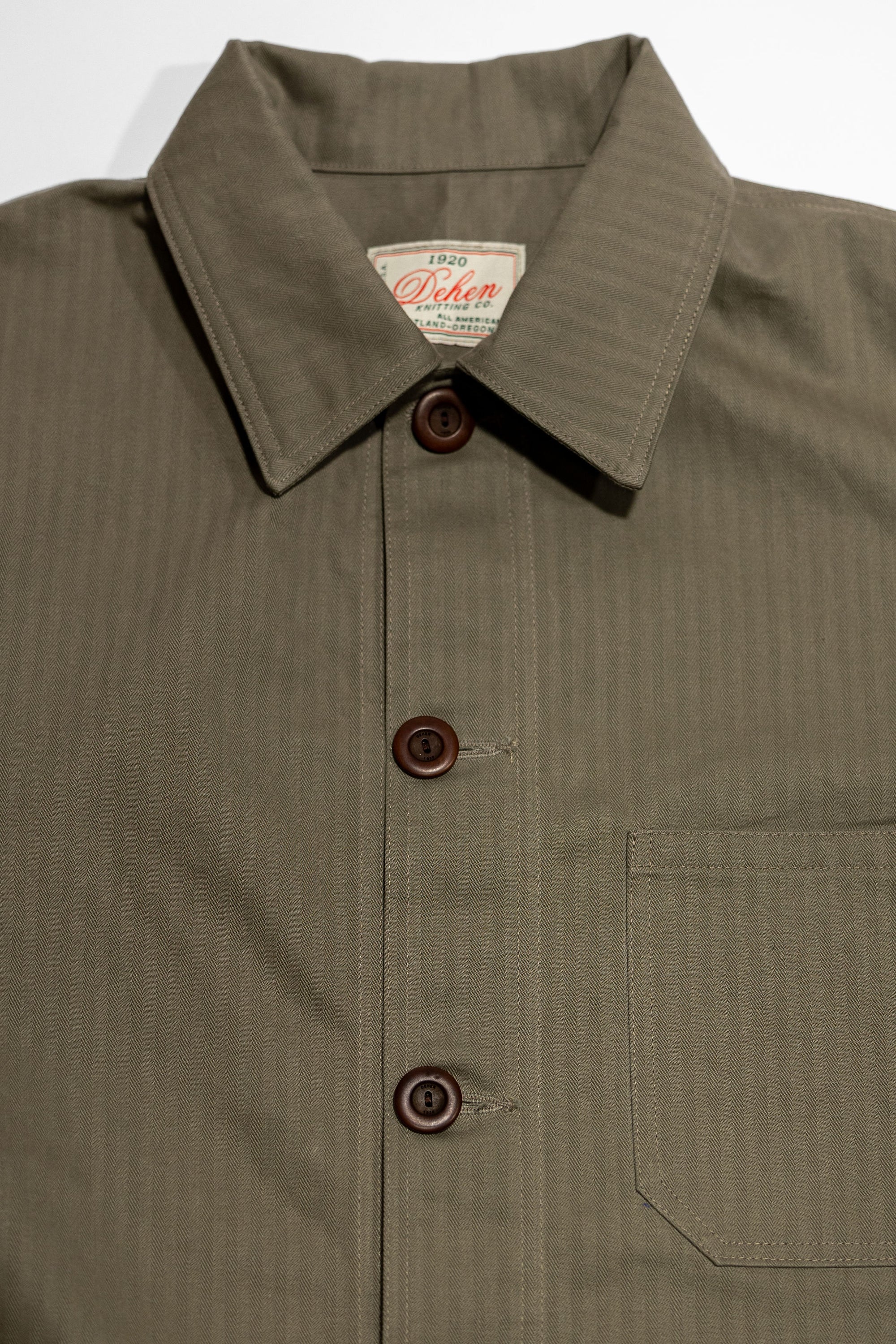 Dehen 1920 Chore Coat - Sage Dry Waxed Cotton. close up of front detail