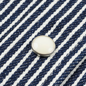 Western style shirt with indigo and white thin vertical stripes close-up on one white snap