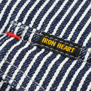 Western style shirt with indigo and white thin vertical stripes close-up on Black and Yellow Iron Heart logo on pocket