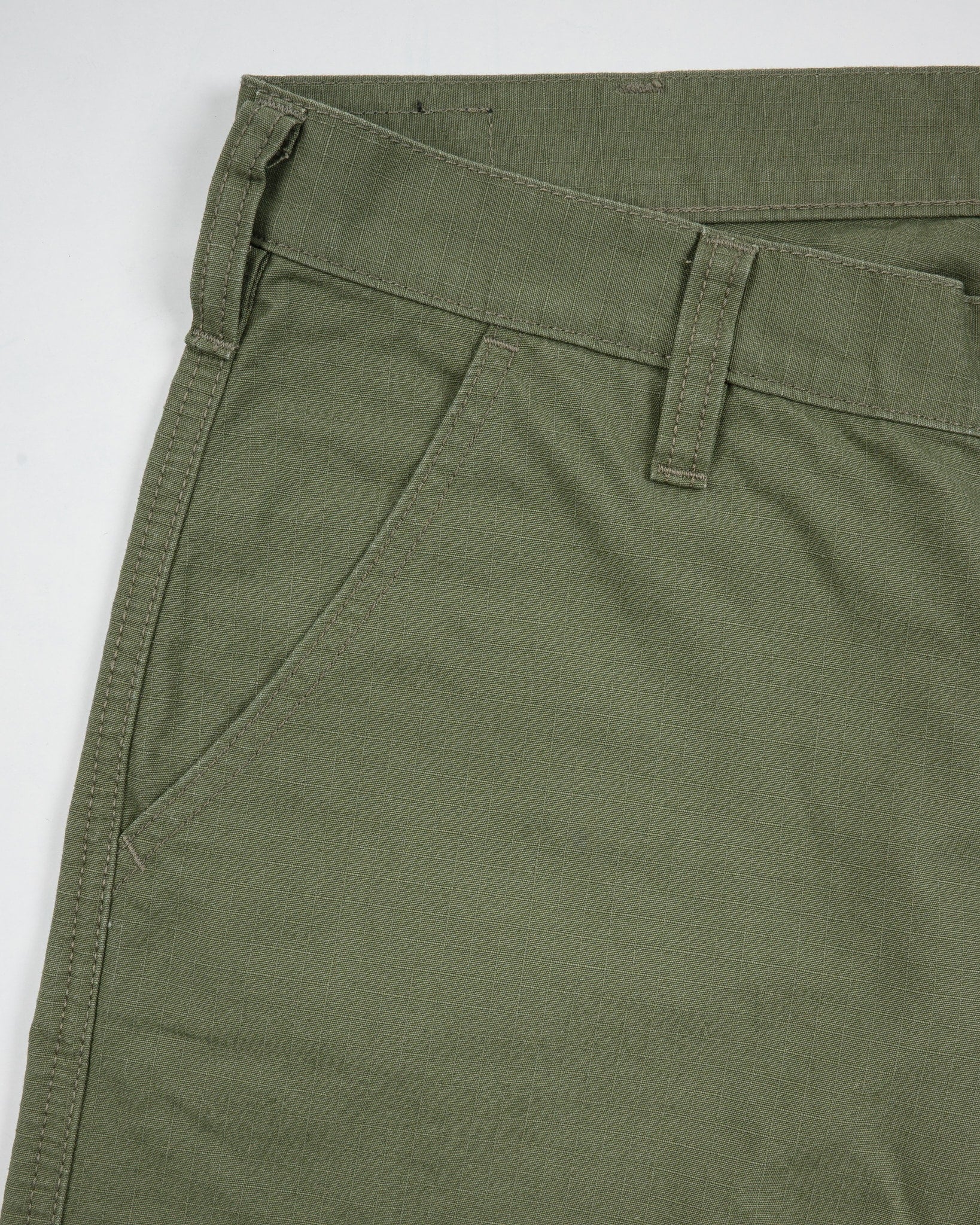 Olive pants front view laying flat closeup on pocket