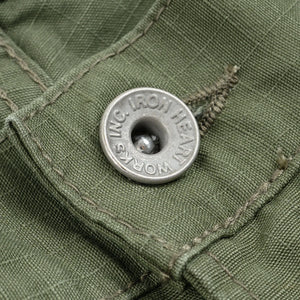 Olive pants laying flat closeup on metal button