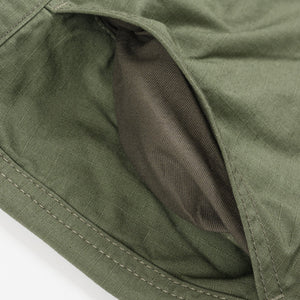 Olive pants laying flat closeup on front pocket