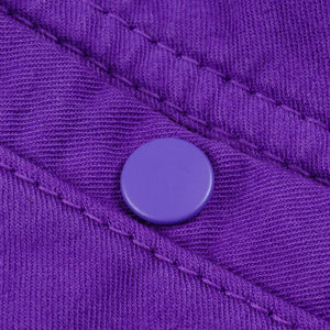 Purple mid length shorts back view laying flat closeup on snap pocket