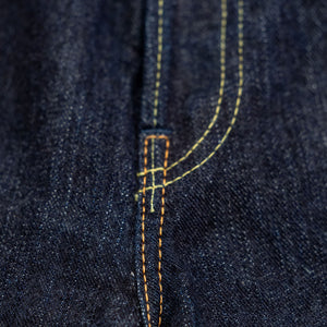 Indigo denim jeans wide cut front view laying flat close up on fly stitching