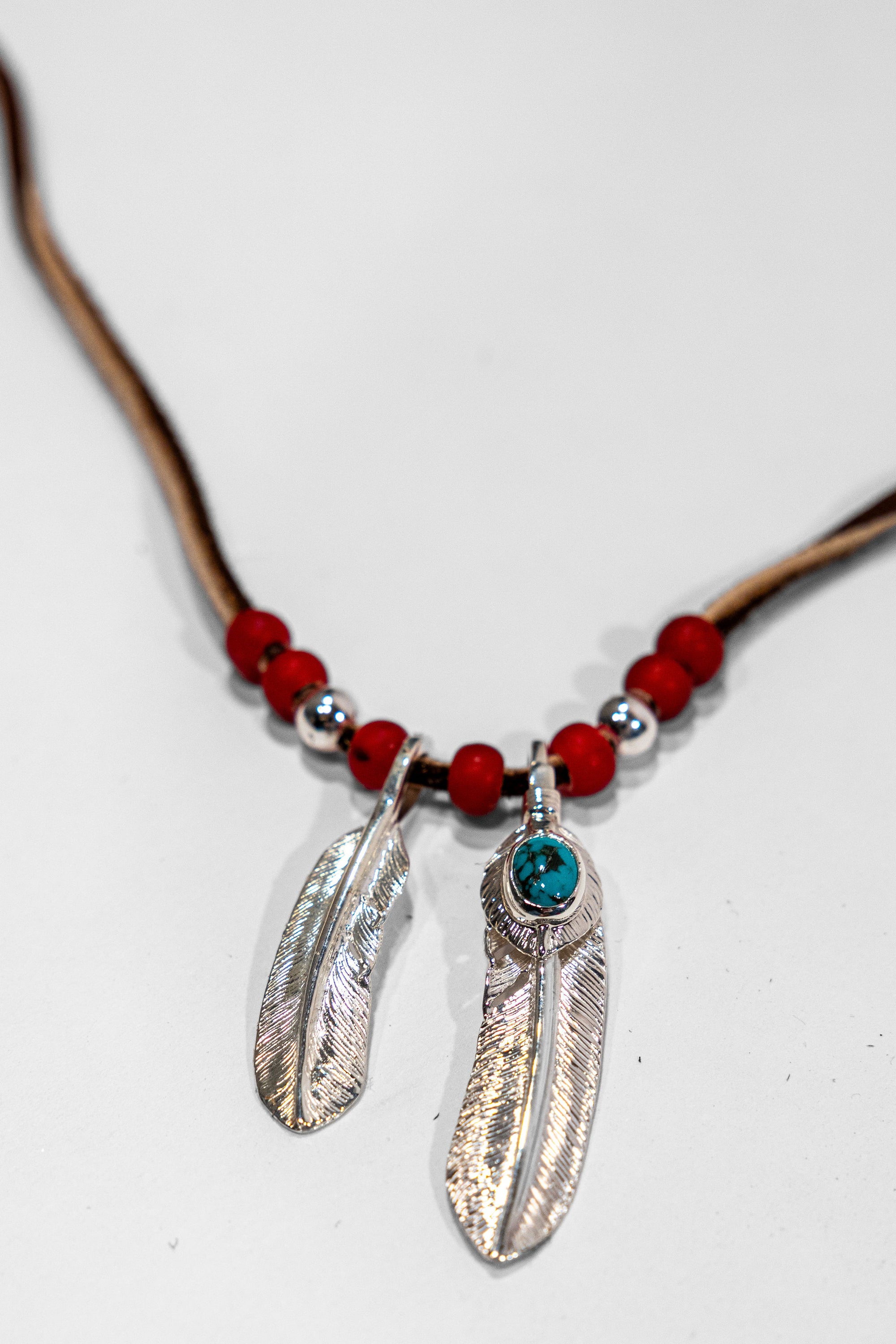 First Arrow’s Deerskin Leather Beaded Necklace Set - Feather and Heart-feather Pendants