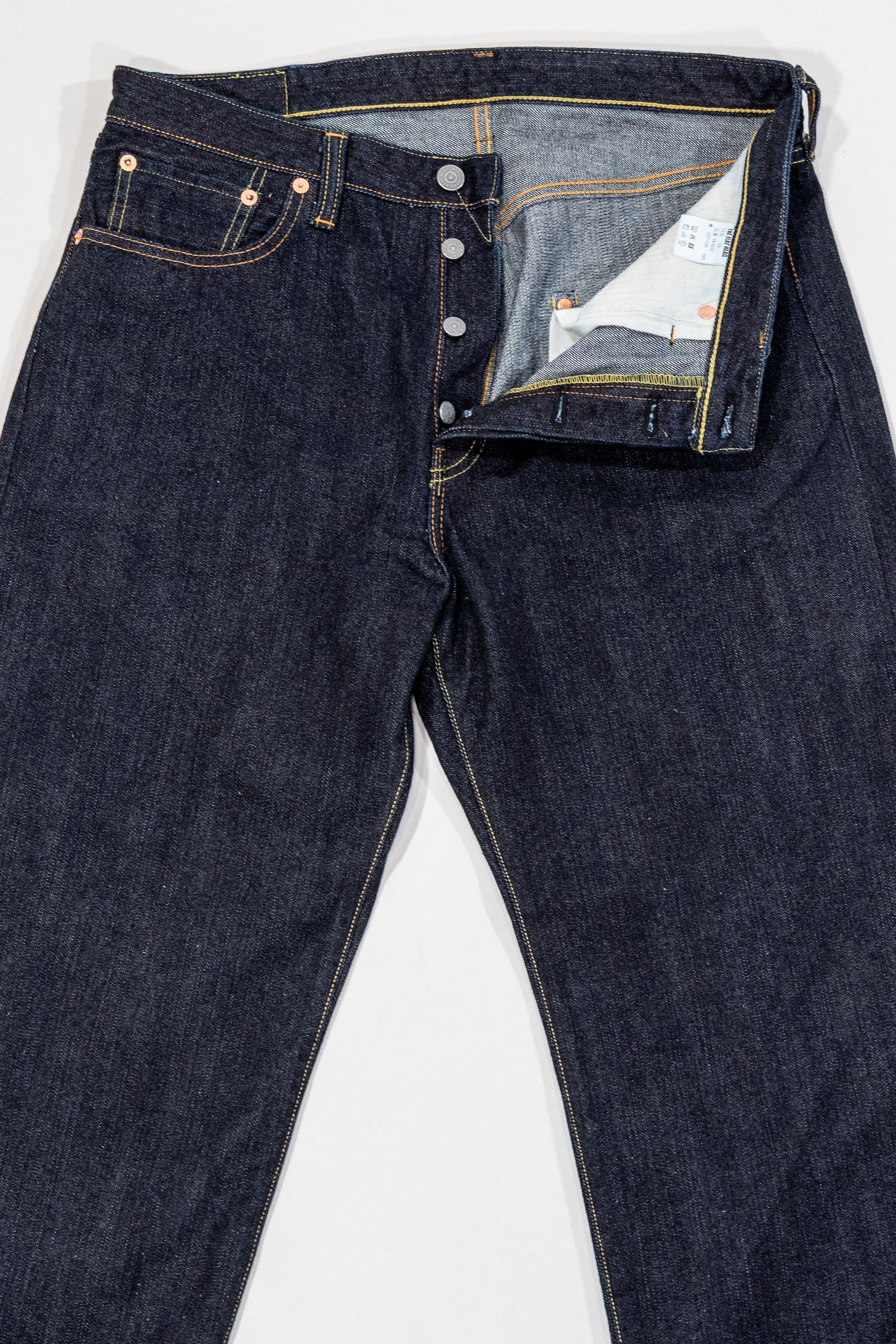 Indigo denim jeans wide cut front view laying flat with fly open