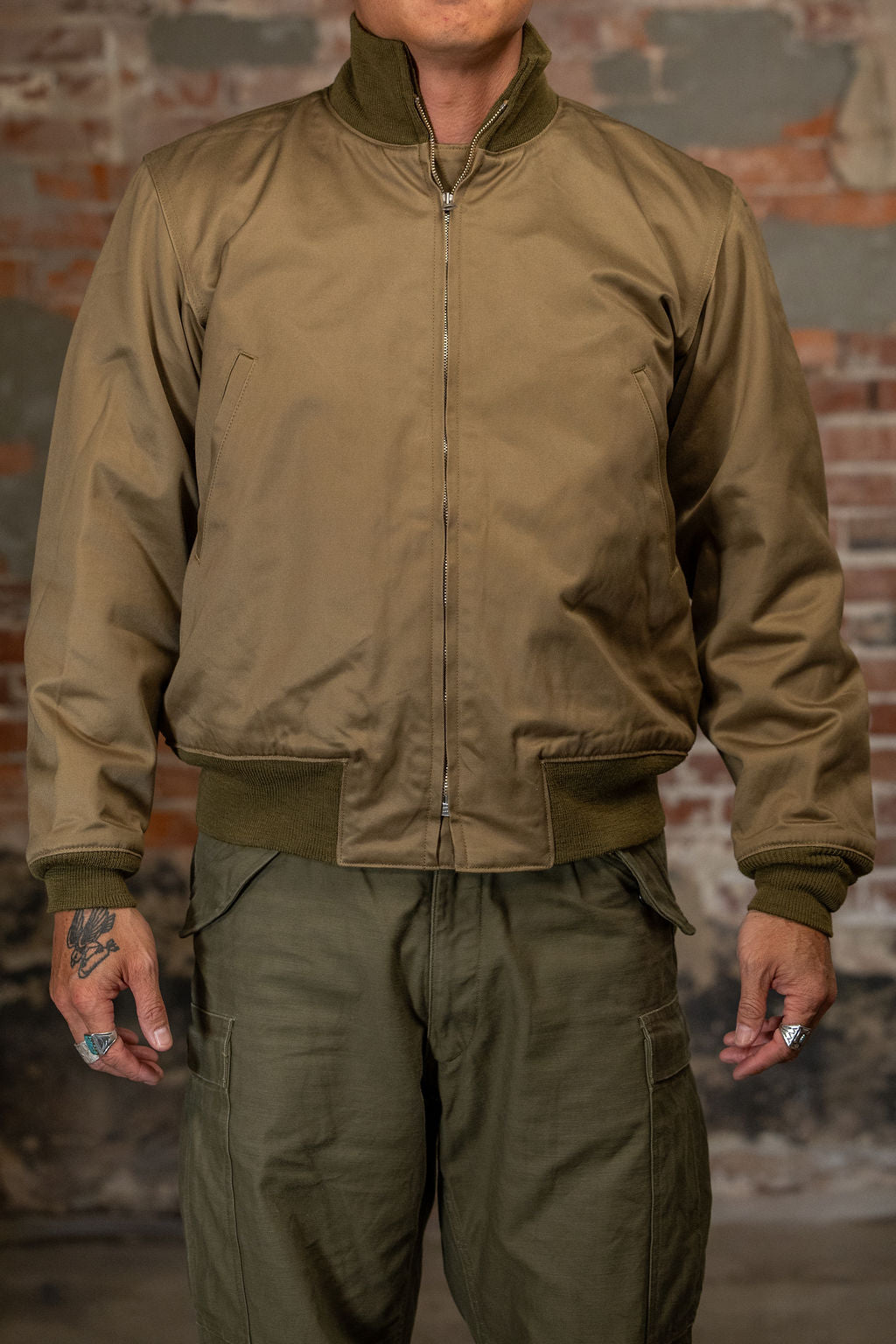 A man wearing the  Buzz Rickson's BR15755 Type Tankers Slash Pocket “Buzz Rickson MFG. Co." in Light Olive Drab, viewed from the front