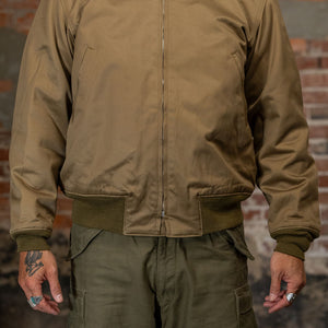 A man wearing the  Buzz Rickson's BR15755 Type Tankers Slash Pocket “Buzz Rickson MFG. Co." in Light Olive Drab, viewed from the front
