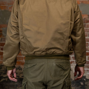 A man wearing the  Buzz Rickson's BR15755 Type Tankers Slash Pocket “Buzz Rickson MFG. Co." in Light Olive Drab, viewed from the rear