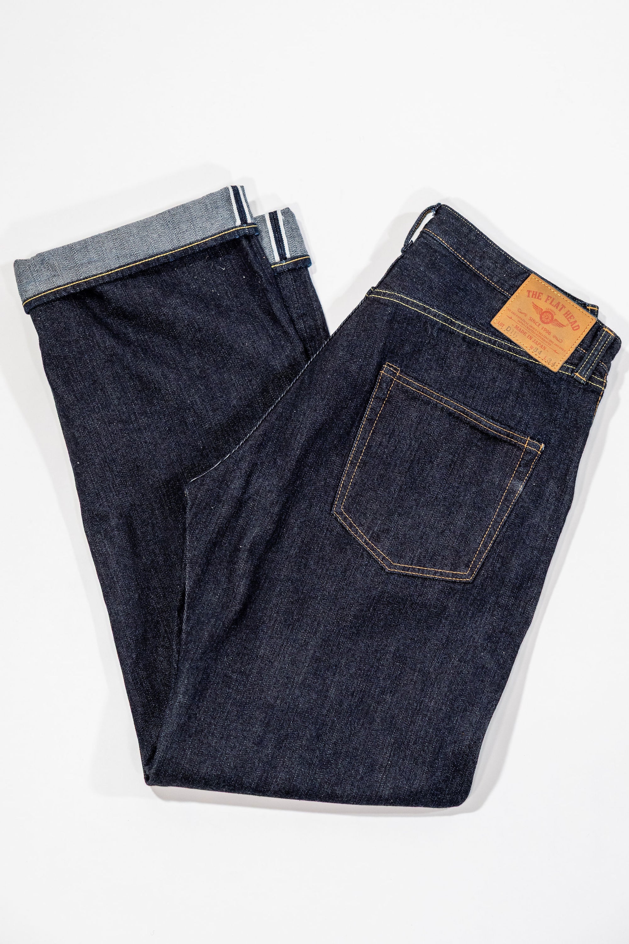 Indigo denim jeans wide cut folded laying flat
