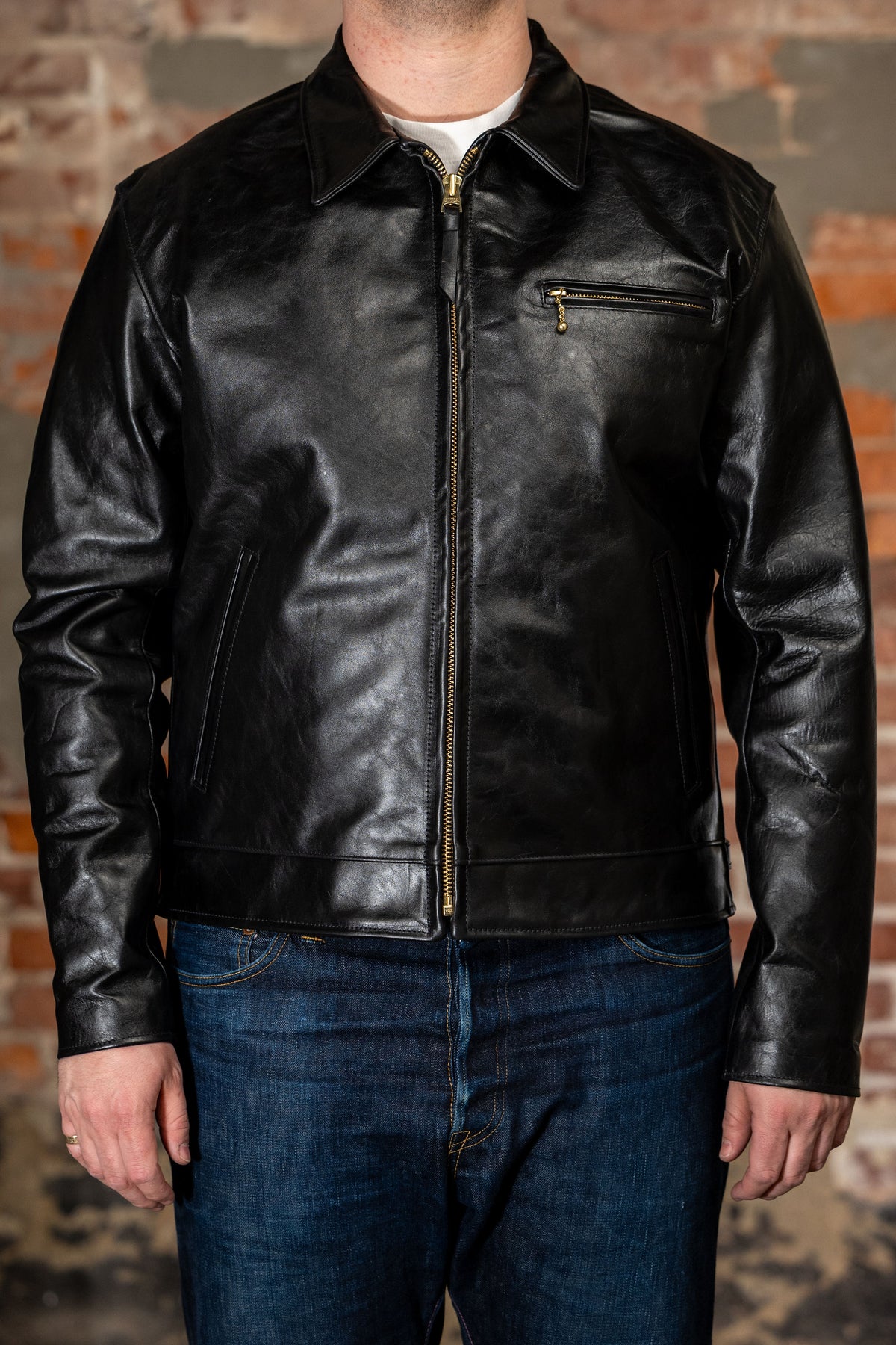 Model wearing back leather jacket from the front.