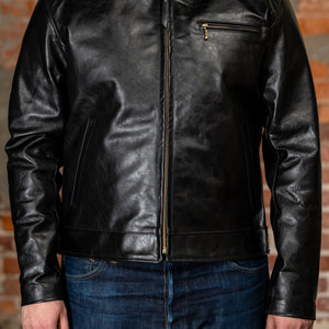 Model wearing back leather jacket from the front.