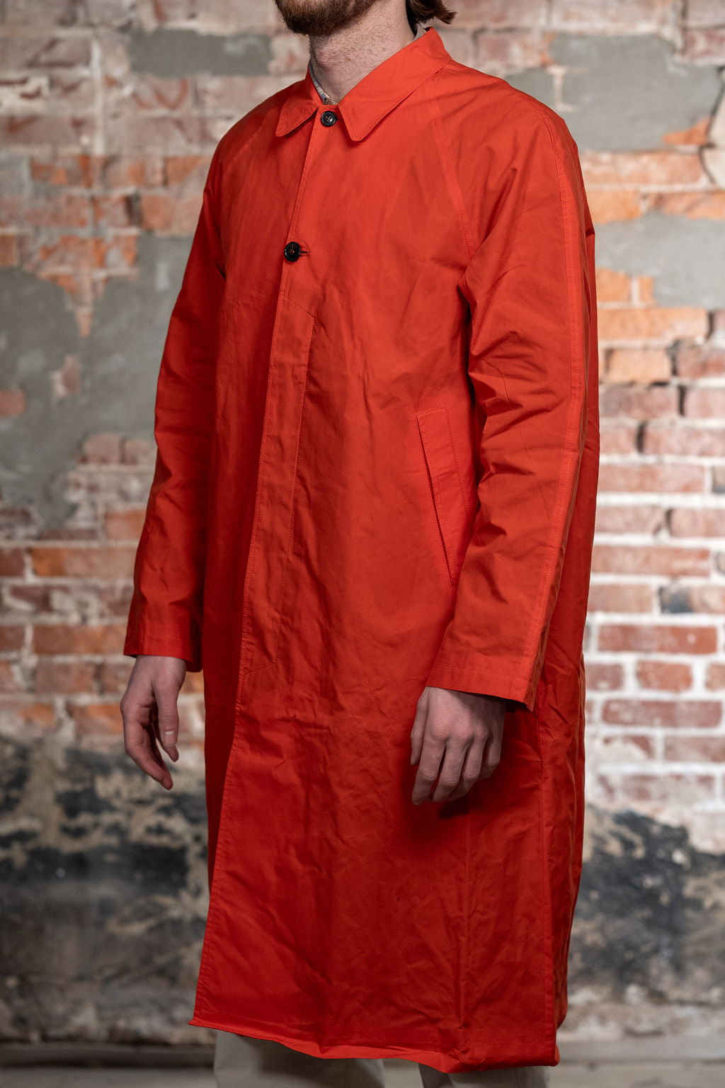Hansen Garments Morten Long Coat - Waxed Orange on model from the side