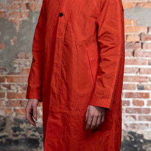 Hansen Garments Morten Long Coat - Waxed Orange on model from the side