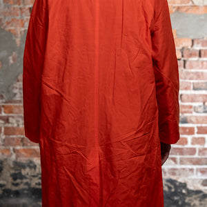 Hansen Garments Morten Long Coat - Waxed Orange on model from the back