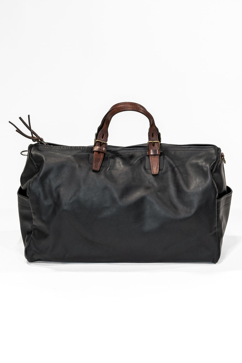 Black leather duffel bag with pockets and brown leather handles back view