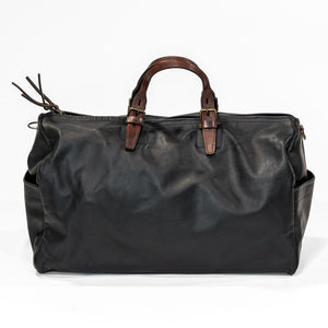 Black leather duffel bag with pockets and brown leather handles back view