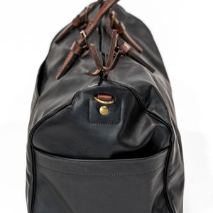Black leather duffel bag with pockets and brown leather handles side two view