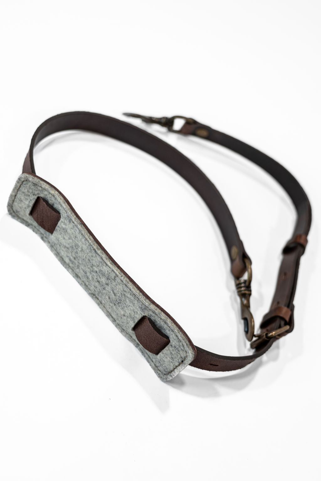 Brown leather strap with trigger hooks underside