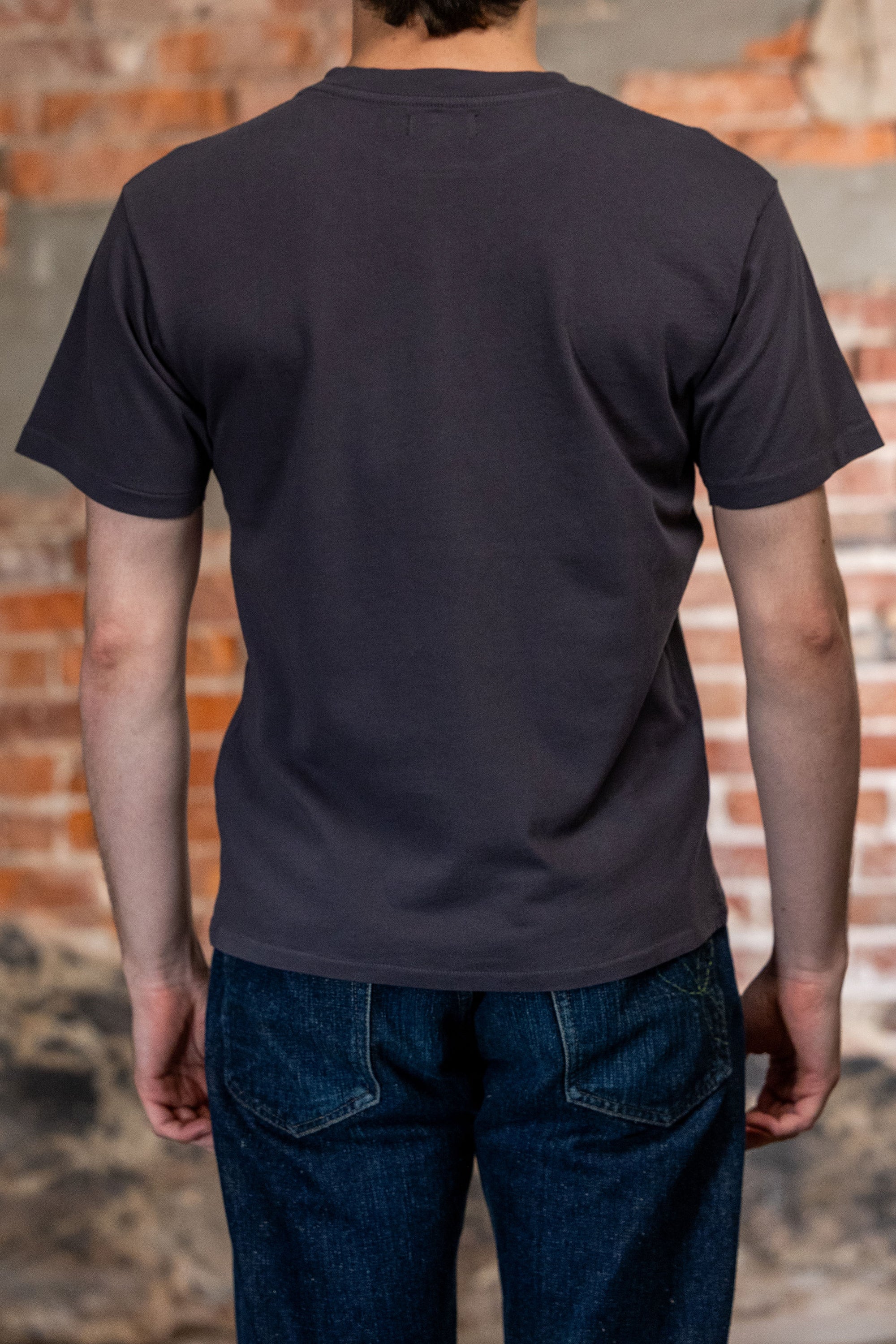 Dark blue premium t-shirt back view on model