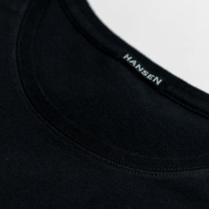 Hansen Garments Julian Crew Neck T-Shirt - Black laid flat. Details on neck stitching. 