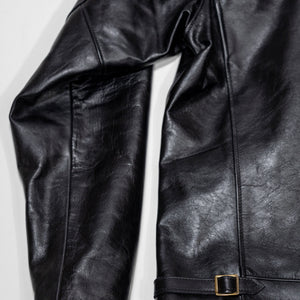 Black leather jacket laid flat on white. Details on back of sleeve and bottom of jacket 