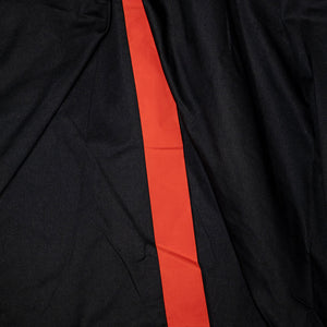 Hansen Garments Morten Long Coat - Waxed Orange laid flat. Details on inside of back slit