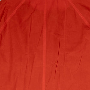 Hansen Garments Morten Long Coat - Waxed Orange laid flat. Details on shoulders and upper back