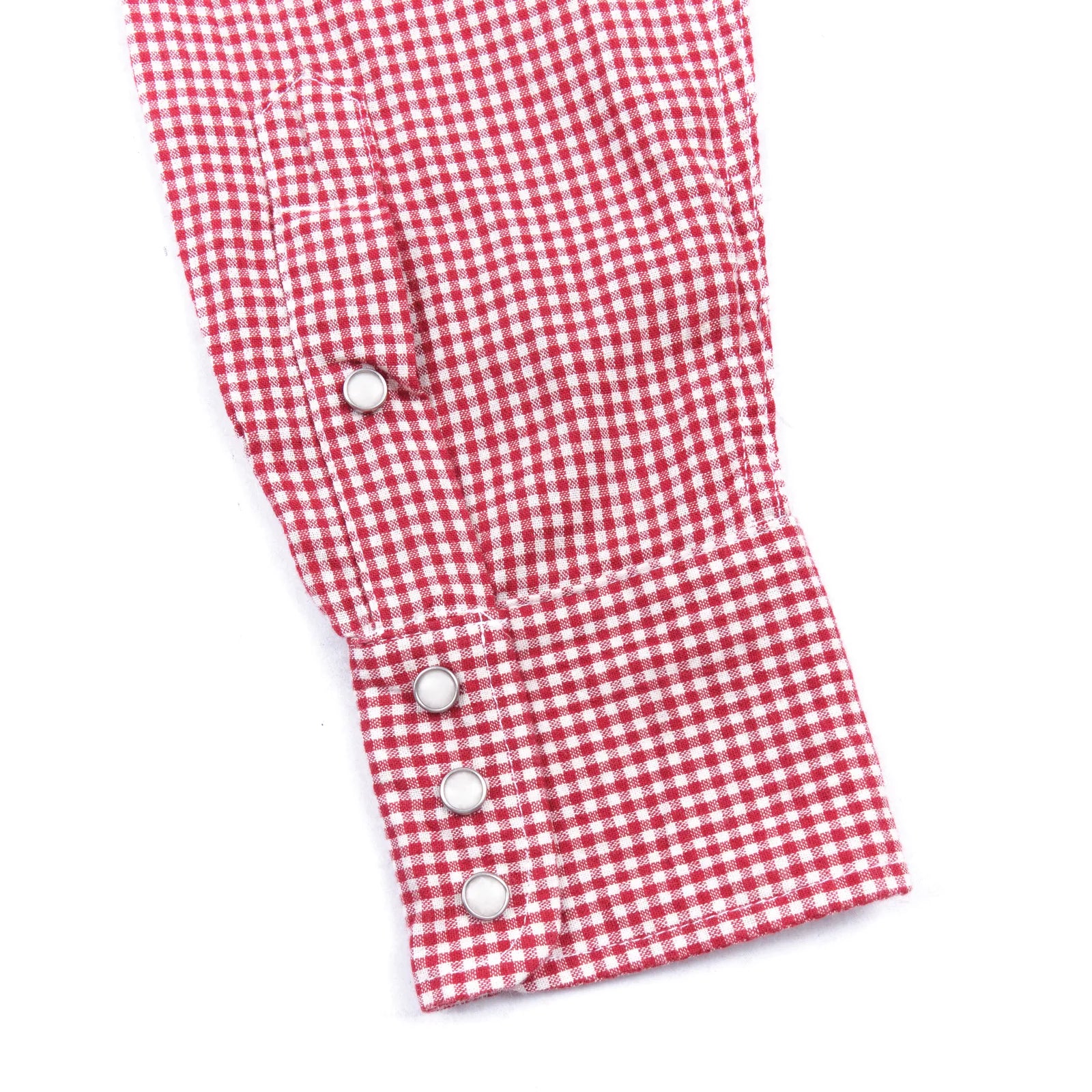 Red and white gingham western-style button-down shirt close up on sleeve cuff laying flat