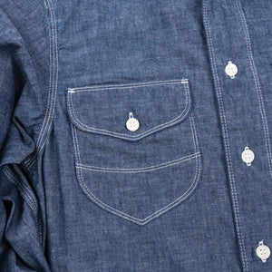 Shirt laid flat on white, from the front. Close up on right chest pocket. 