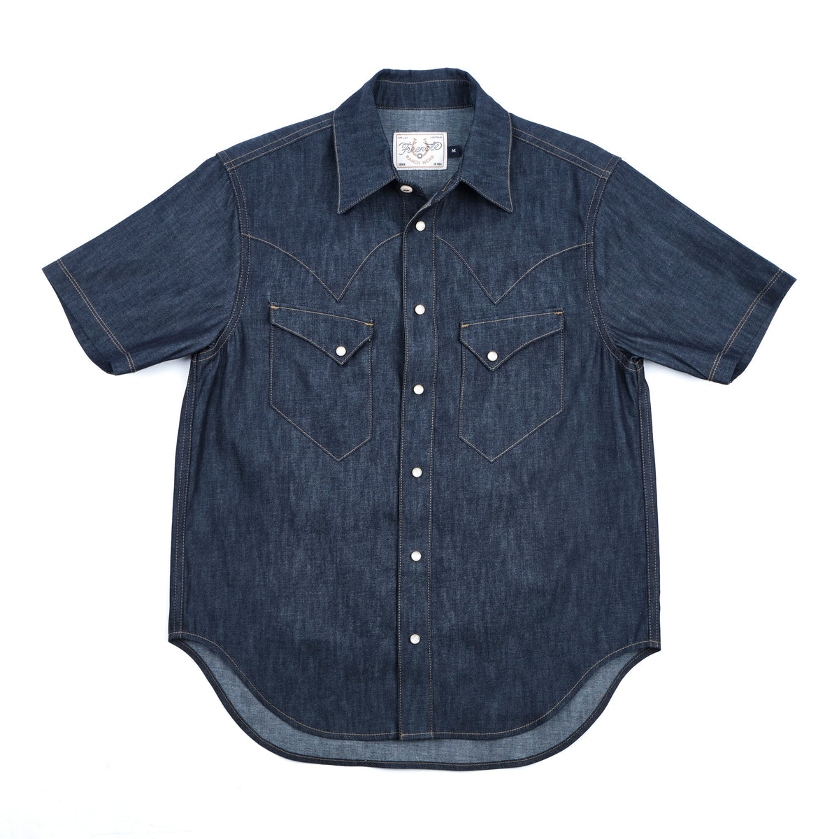 Dark indigo denim western-style short sleeve shirt with white snaps, front view laying flat
